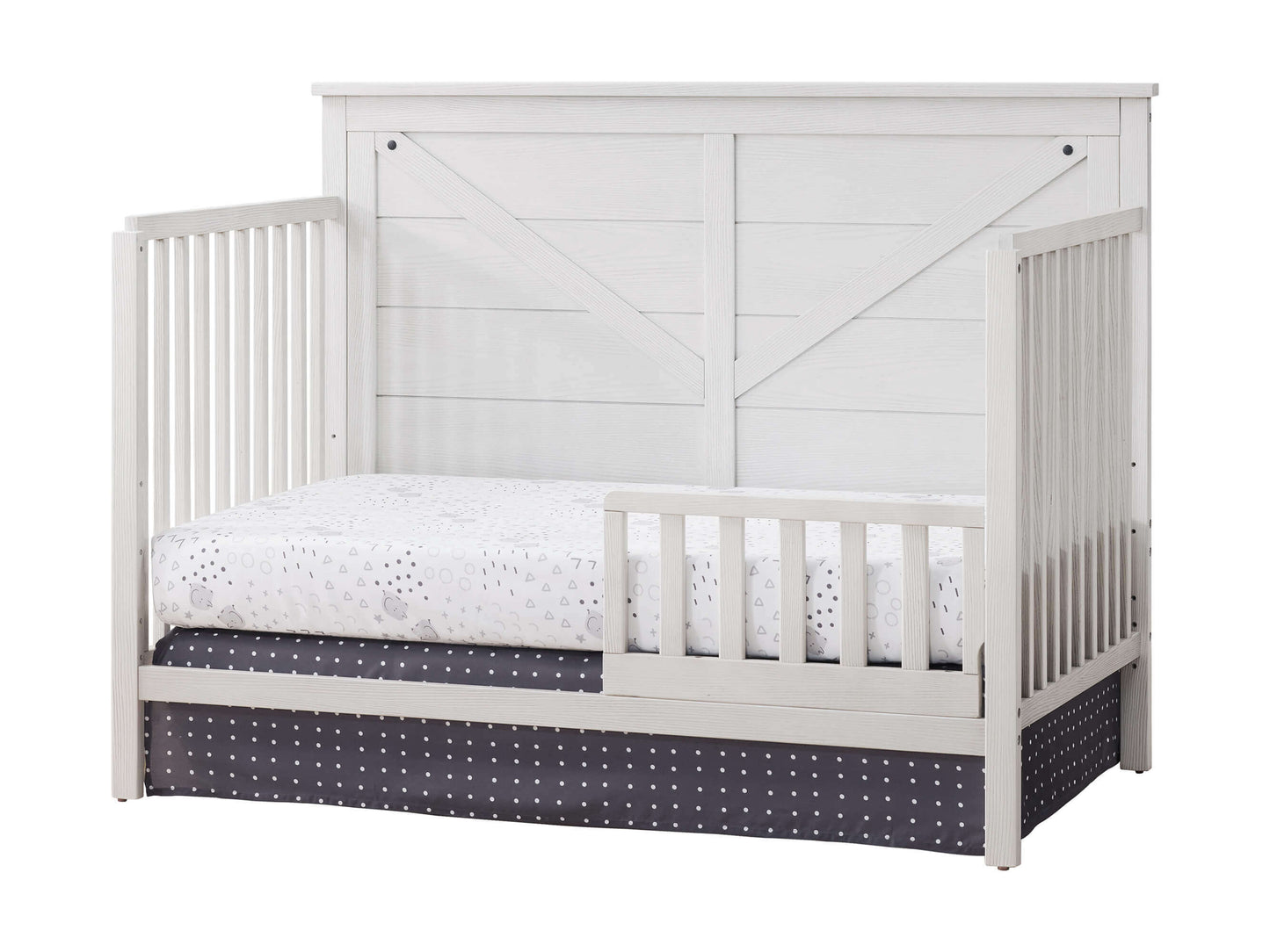 Montauk 4-in-1 Convertible Crib - Inclined Side View of Montauk 4-in-1 Convertible Crib Barn White with Guard Rail