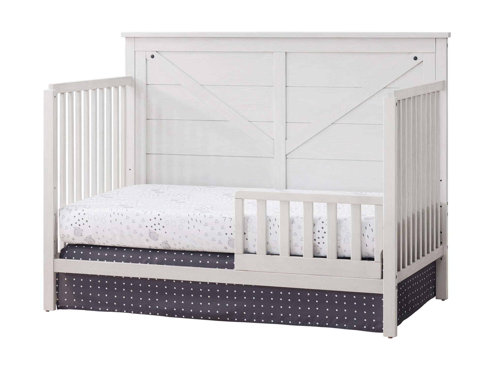 Montauk 4-in-1 Convertible Crib - Inclined Side View of Montauk 4-in-1 Convertible Crib Barn White with Guard Rail
