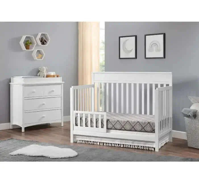 Castle Hill 4-in-1 Convertible Crib - Lifestyle Image Inclined Side View of Castle Hill 4-in-1 Convertible Crib Barn White with Guard Rail