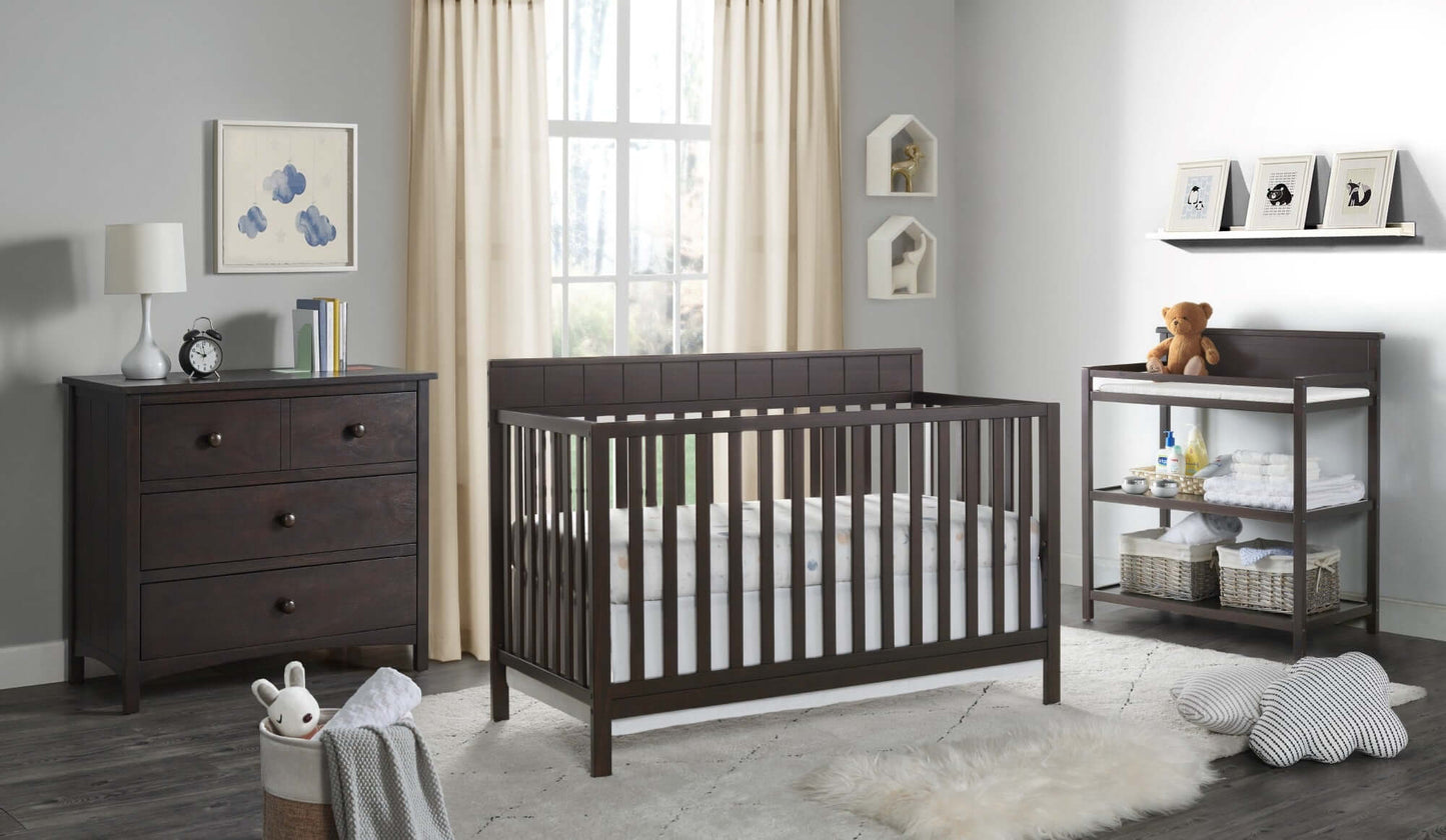 Logan 4-in-1 Convertible Crib - Lifestyle Image Inclined Side View of Logan 4-in-1 Convertible Crib Espresso with 3 Drawer Dresser