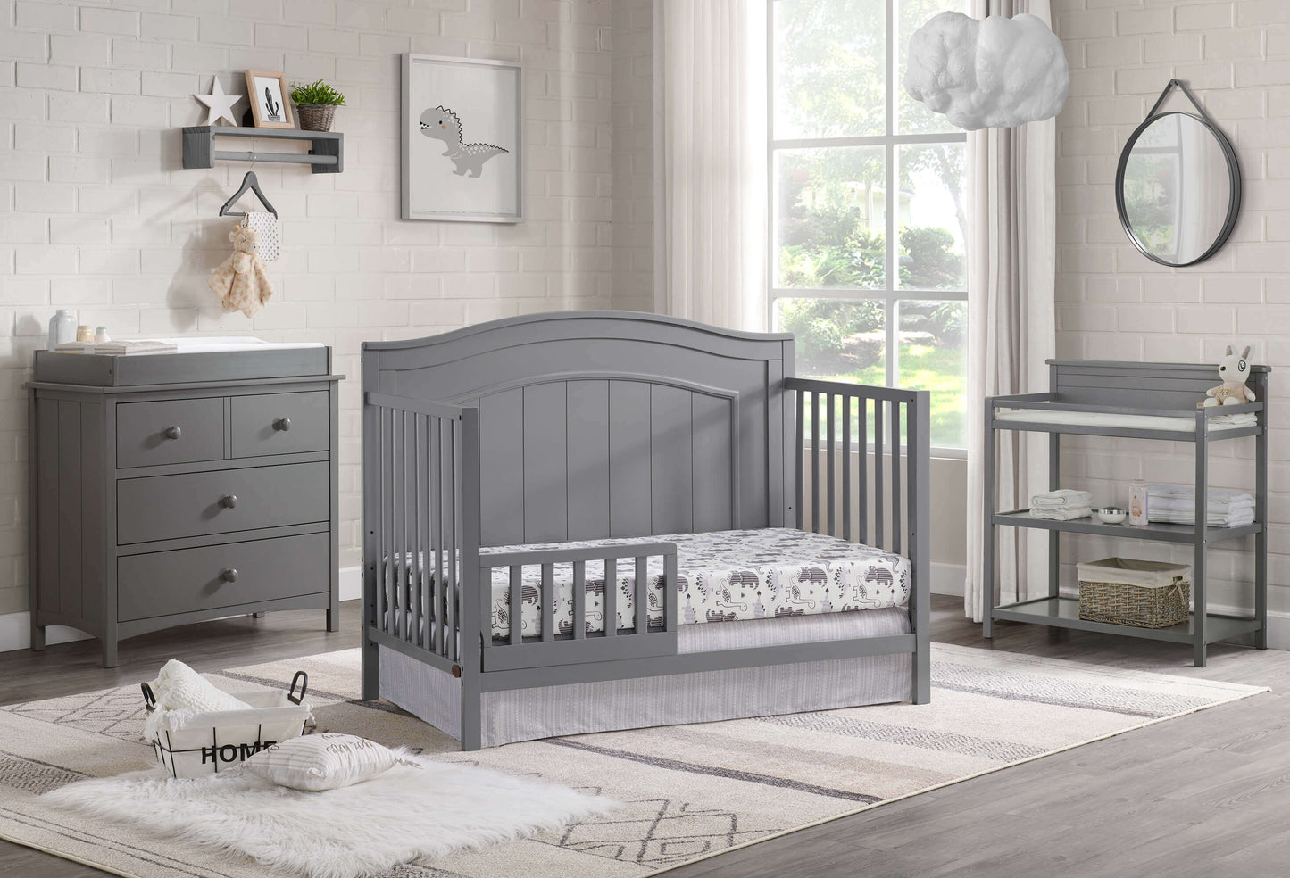 Nolan 4 in 1 Convertible Crib - Lifestyle Image Inclined Side View of Nolan 4 in 1 Convertible Crib Dove Gray with Guard Rail