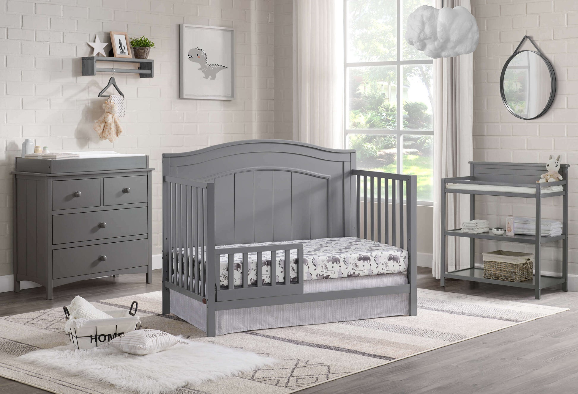 Nolan 4 in 1 Convertible Crib - Lifestyle Image Inclined Side View of Nolan 4 in 1 Convertible Crib Dove Gray with Guard Rail