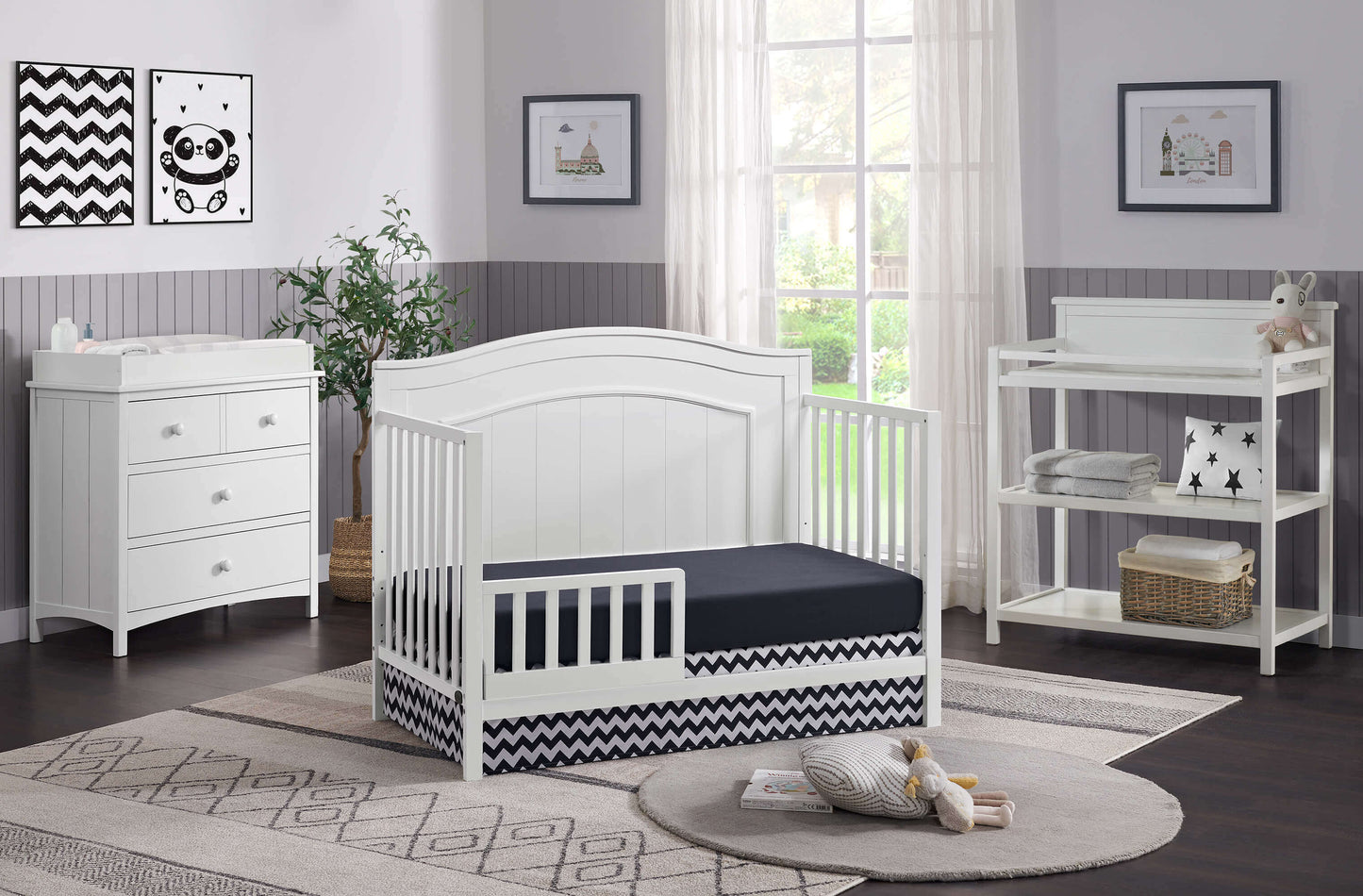 Nolan 4 in 1 Convertible Crib - Lifestyle Image Inclined Side View of Nolan 4 in 1 Convertible Crib Snow White with Guard Rail