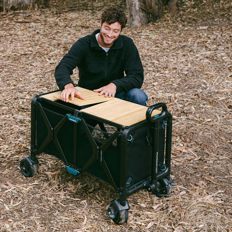 S5 Convertible Utility Wagon - Lifestyle Image of man Unfolding S5 Convertible Utility Wagon Black