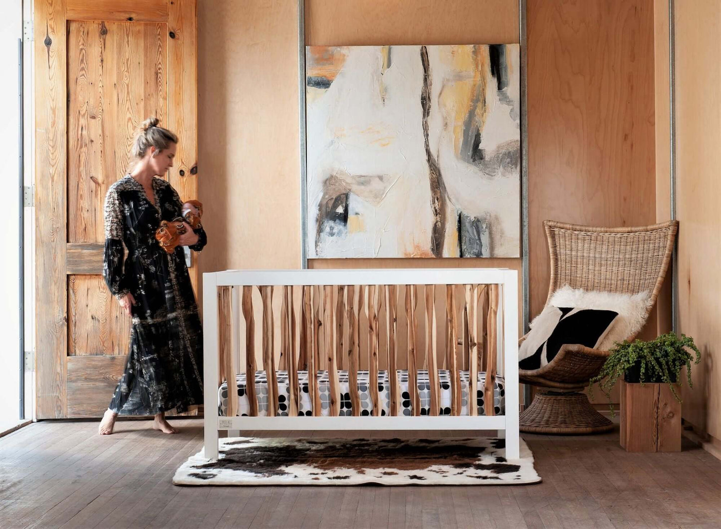 Branch 4 in 1 Convertible Crib - Lifestyle Image of 4 in 1 Convertible Crib Acacia with Mother Carrying baby