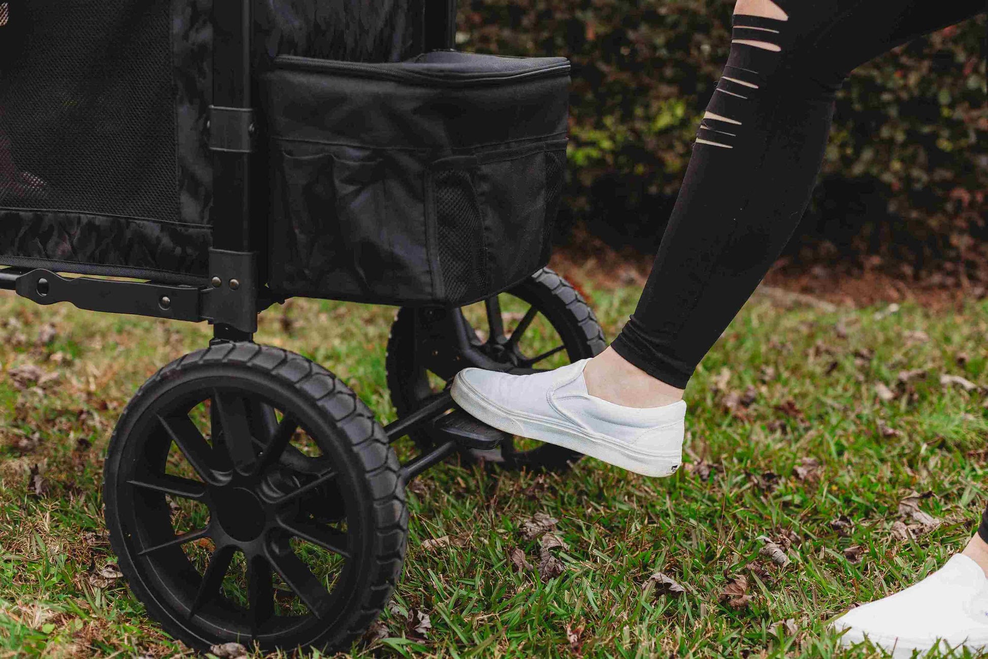 W2 Luxe Double Stroller Wagon - Lifestyle Image of Brakes in usage of W2 Luxe Double Stroller Wagon Black