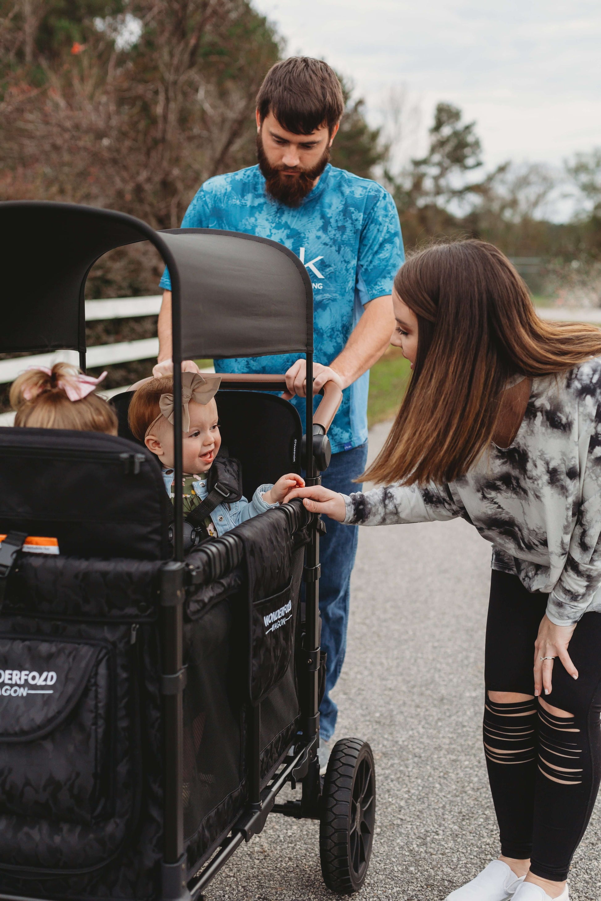 W2 Luxe Double Stroller Wagon - Zoomed Lifestyle Image of Women Playing with Baby on W2 Luxe Double Stroller Wagon Elite Black Como