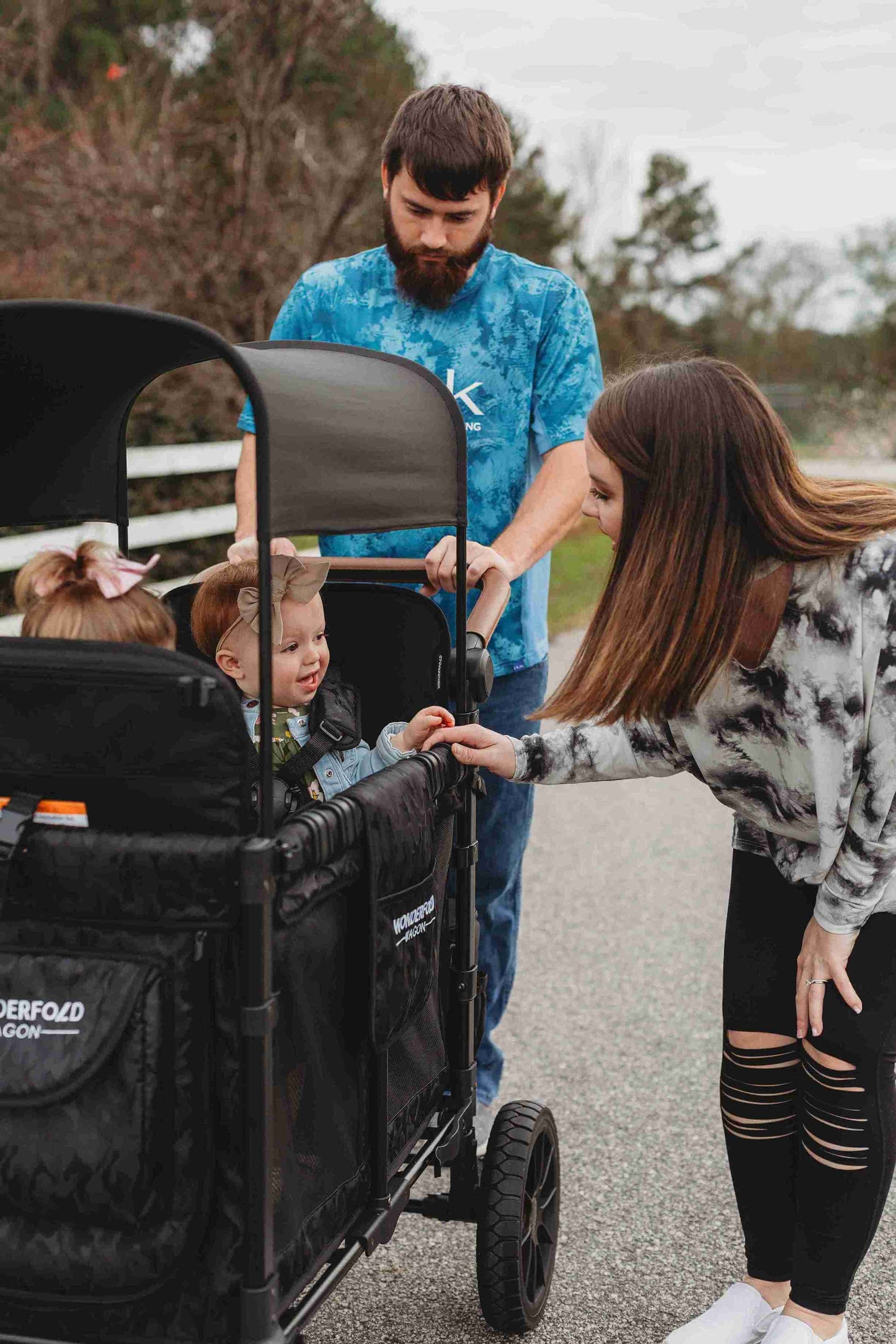 W2 Luxe Double Stroller Wagon - Zoomed Lifestyle Image of Women Playing with Baby on W2 Luxe Double Stroller Wagon Black