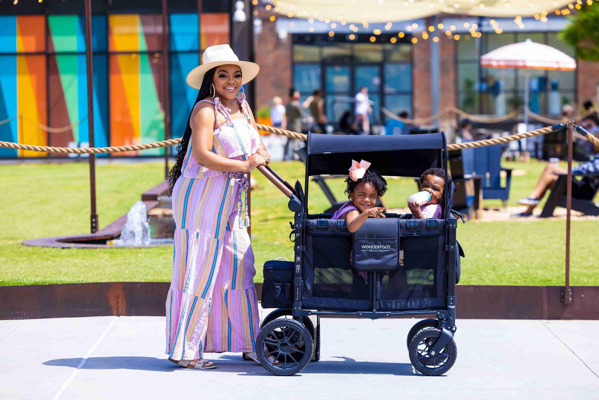 W2 Luxe Double Stroller Wagon - Lifestyle Image of Woman With Two Children on W2 Luxe Double Stroller Wagon Gray-1
