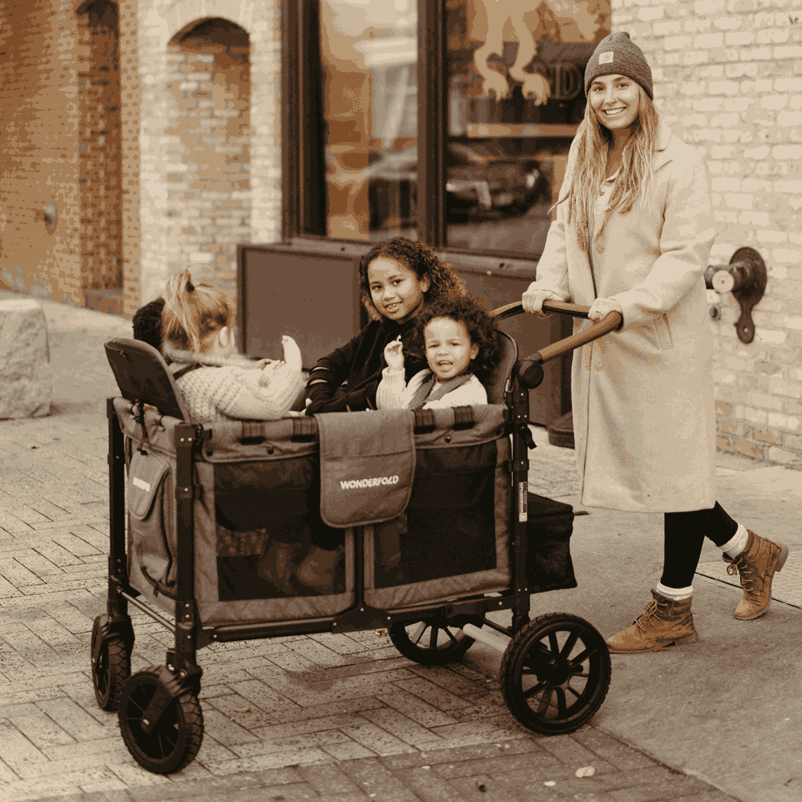 W4 Luxe Quad Stroller Wagon - Lifestyle Image Inclined View of Mother with Toddler's on W4 Luxe Quad Stroller Wagon