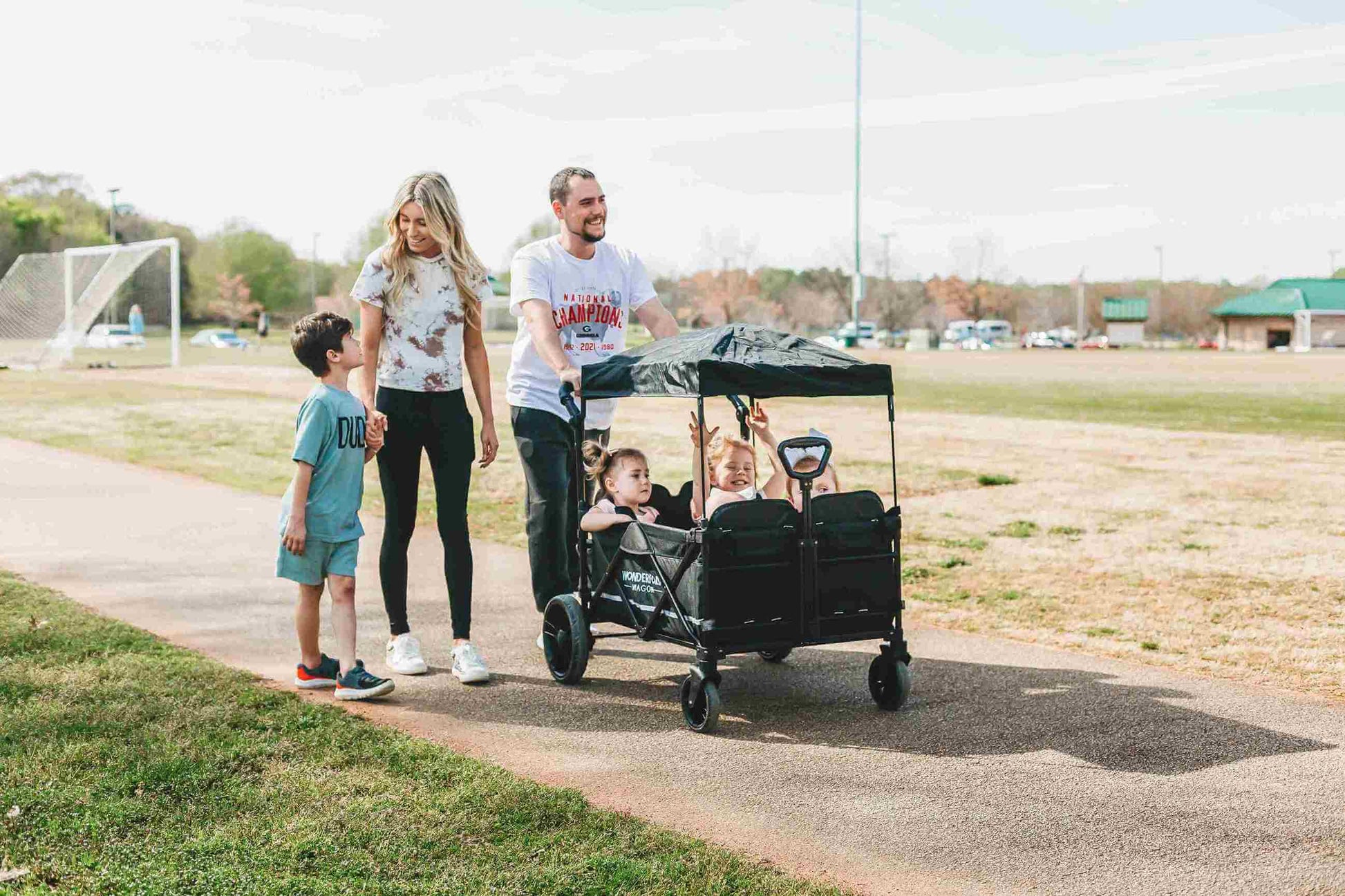 X4 Push + Pull Quad Stroller Wagon - Lifestyle Image of Family Enjoying with X4 Push + Pull Quad Stroller Wagon Black