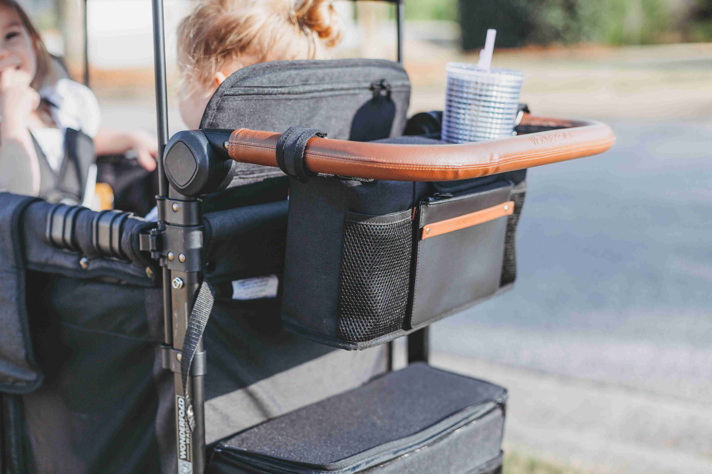Parent Console Snack Activity Tray with 4 Cupholders - Lifestyle Image Zoom View of Parent Console with 4 Insulated Cup Holders Black Hanging on the Front of Wagon