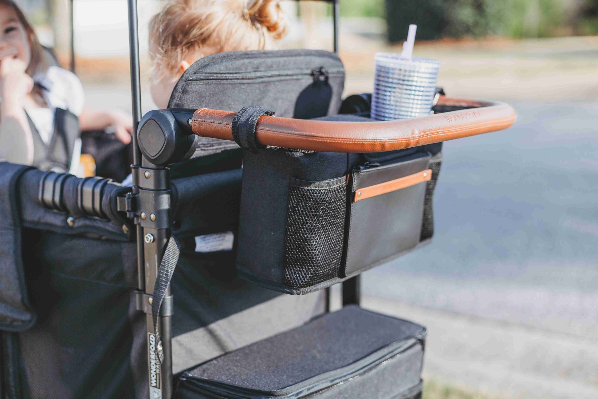 Parent Console Snack Activity Tray with 4 Cupholders - Lifestyle Image Zoom View of Parent Console with 4 Insulated Cup Holders Black Hanging on the Front of Wagon
