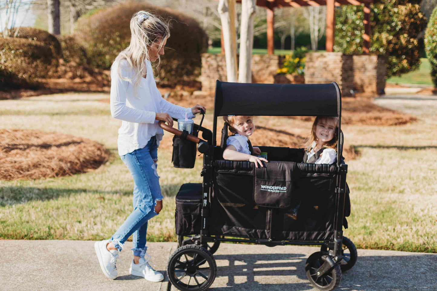 Parent Console Snack Activity Tray with 4 Cupholders - Lifestyle Image Zoom View of Women Holding Parent Console with 4 Insulated Cup Holders Black With Children