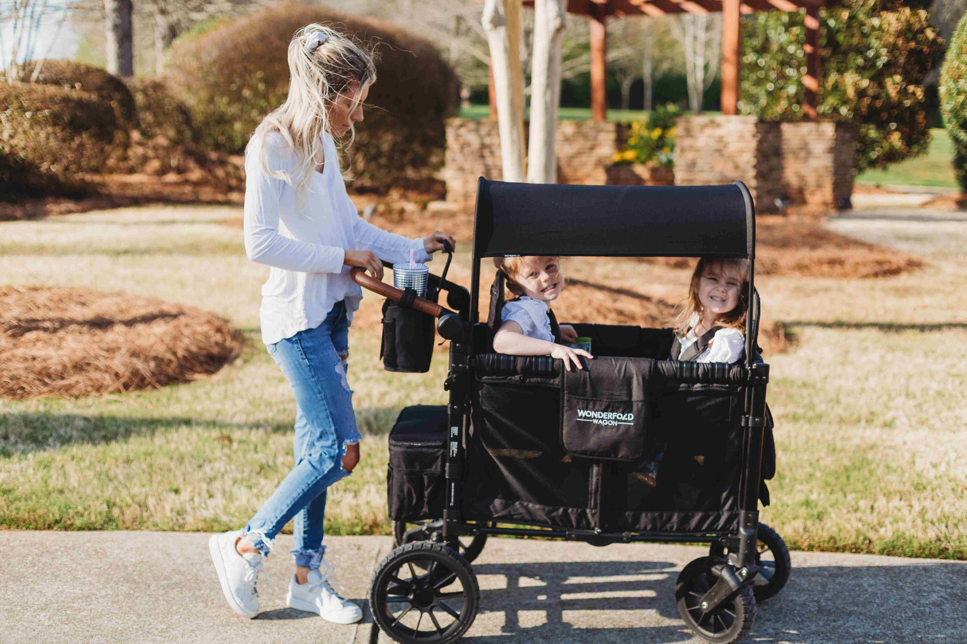 Parent Console Snack Activity Tray with 4 Cupholders - Lifestyle Image Zoom View of Women Holding Parent Console with 4 Insulated Cup Holders Black With Children