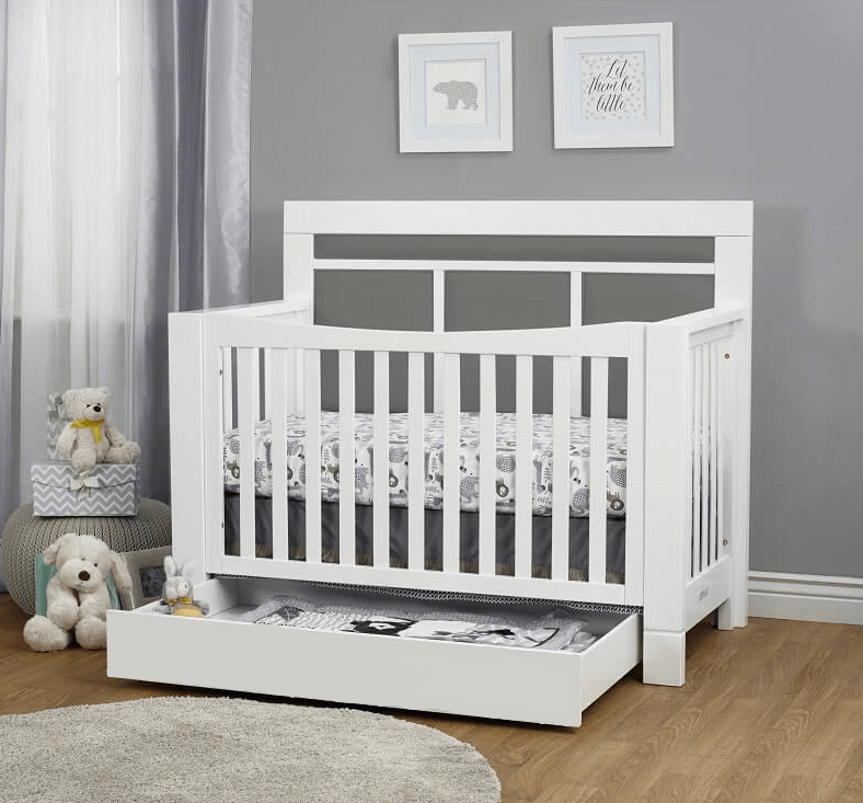 Crystal Convertible Crib - Lifestyle Image Inclined Side View of Crystal Convertible Crib Multi Tone Gray with Open Drawer