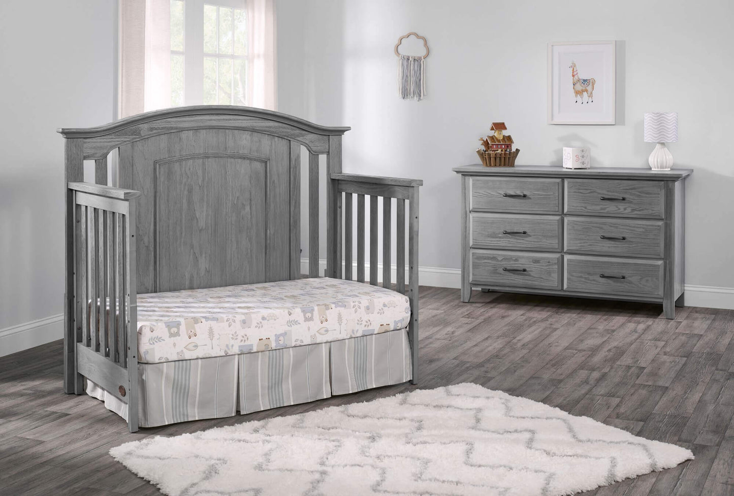 Willowbrook 4-in-1 Convertible Crib - Lifestyle Image Inclined Side View of Willowbrook Daybed Graphite Gray