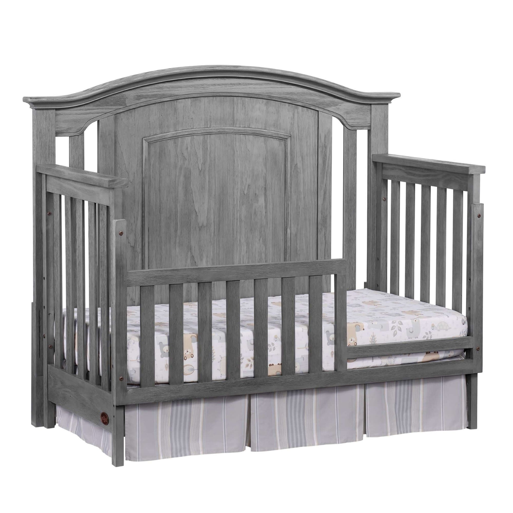 Willowbrook 4-in-1 Convertible Crib - Inclined Side View of Willowbrook 4-in-1 Convertible Crib Graphite Gray with Guard Rail