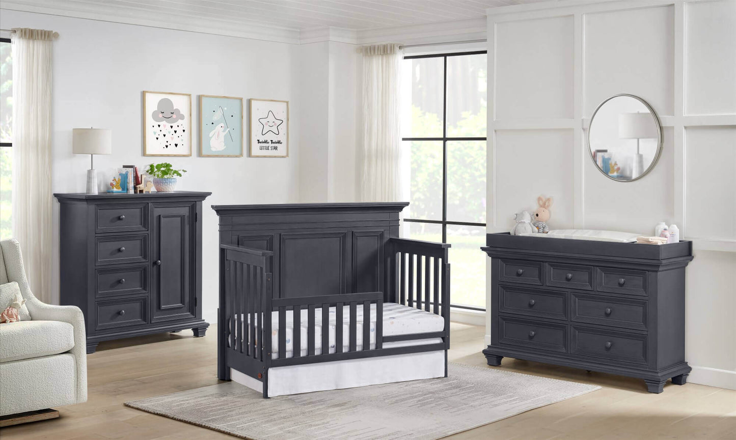 Weston 4 In 1 Convertible Crib - Lifestyle Image Inclined Side View of Weston 4 In 1 Convertible Crib with Guard Rail Midnight Slate