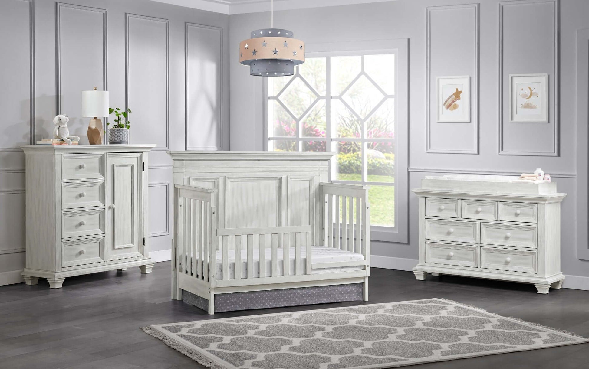 Weston 4 In 1 Convertible Crib - Lifestyle Image Inclined Side View of Weston 4 In 1 Convertible Crib with Guard Rail Vintage White