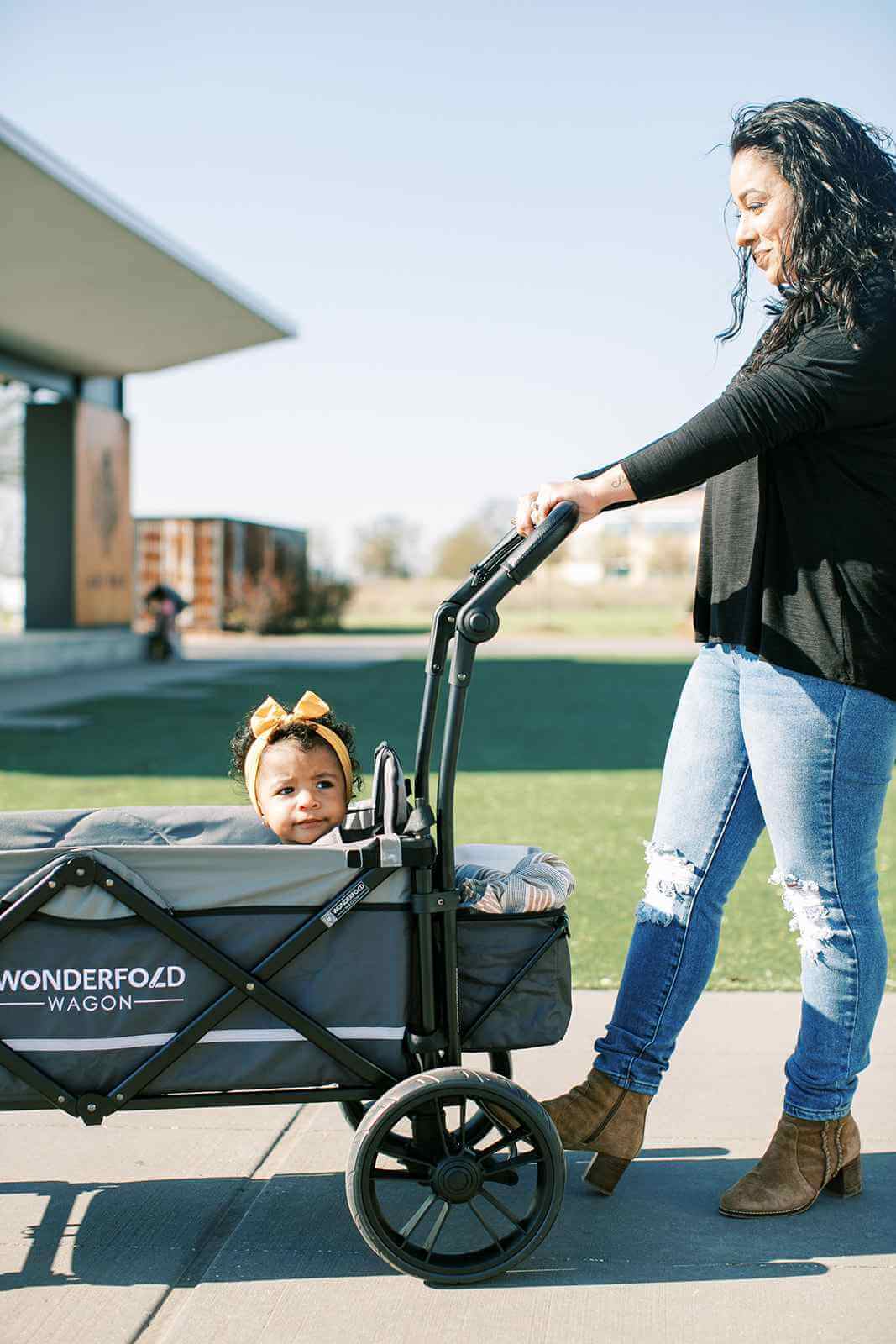 X2 Double Stroller Wagon - Lifestyle Image of Mother Holding Push Handle of X2 Double Stroller Wagon with Baby Inside Wagon Gray-1