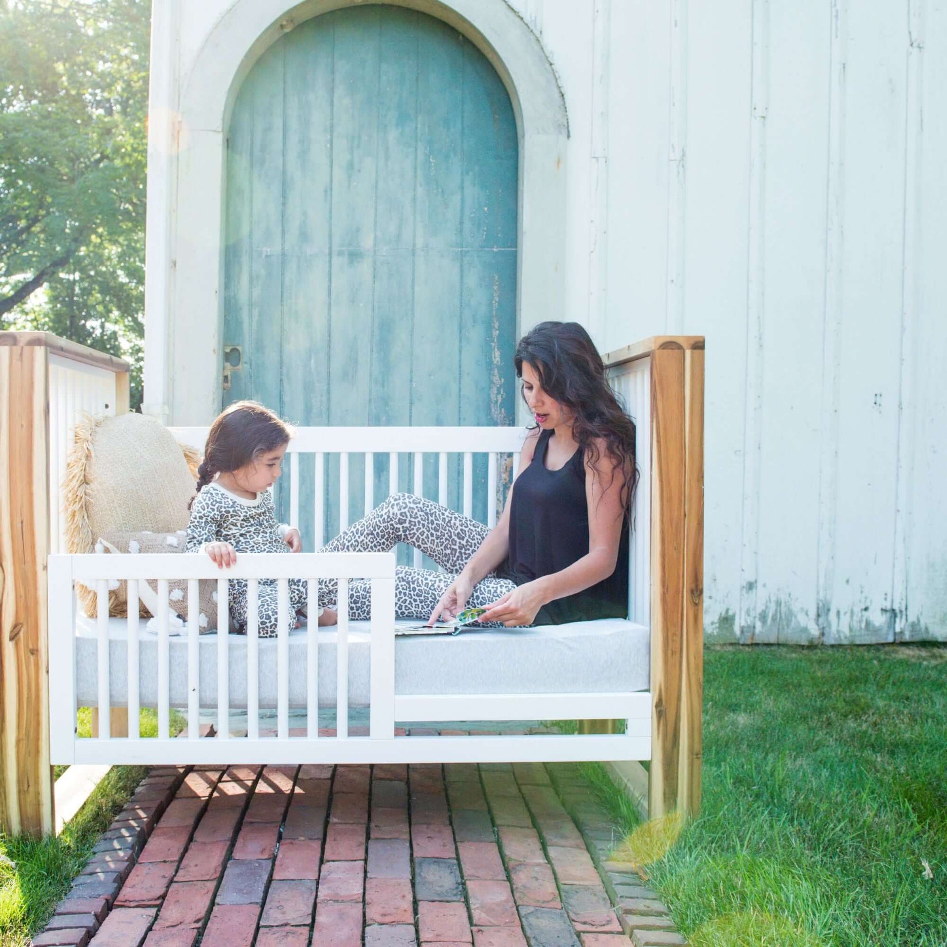 True Traditional 3 in 1 Crib - Outdoor Lifestyle Image of Traditional 3 in 1 Crib Acacia With Snow with Mother and Child