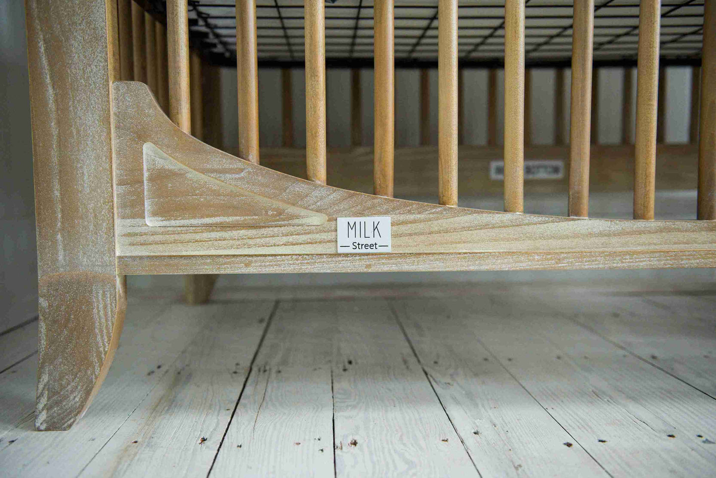 Cameo Oval Convertible Crib - Lifestyle Image Bottom View of Oval Convertible Crib Toast