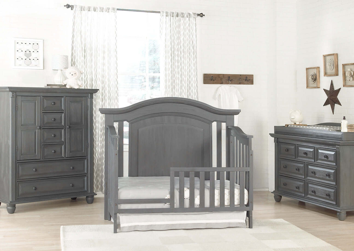 London Lane Guard Rail - Lifestyle Image Inclined Side View of London Lane Crib with Guard Rail Gray