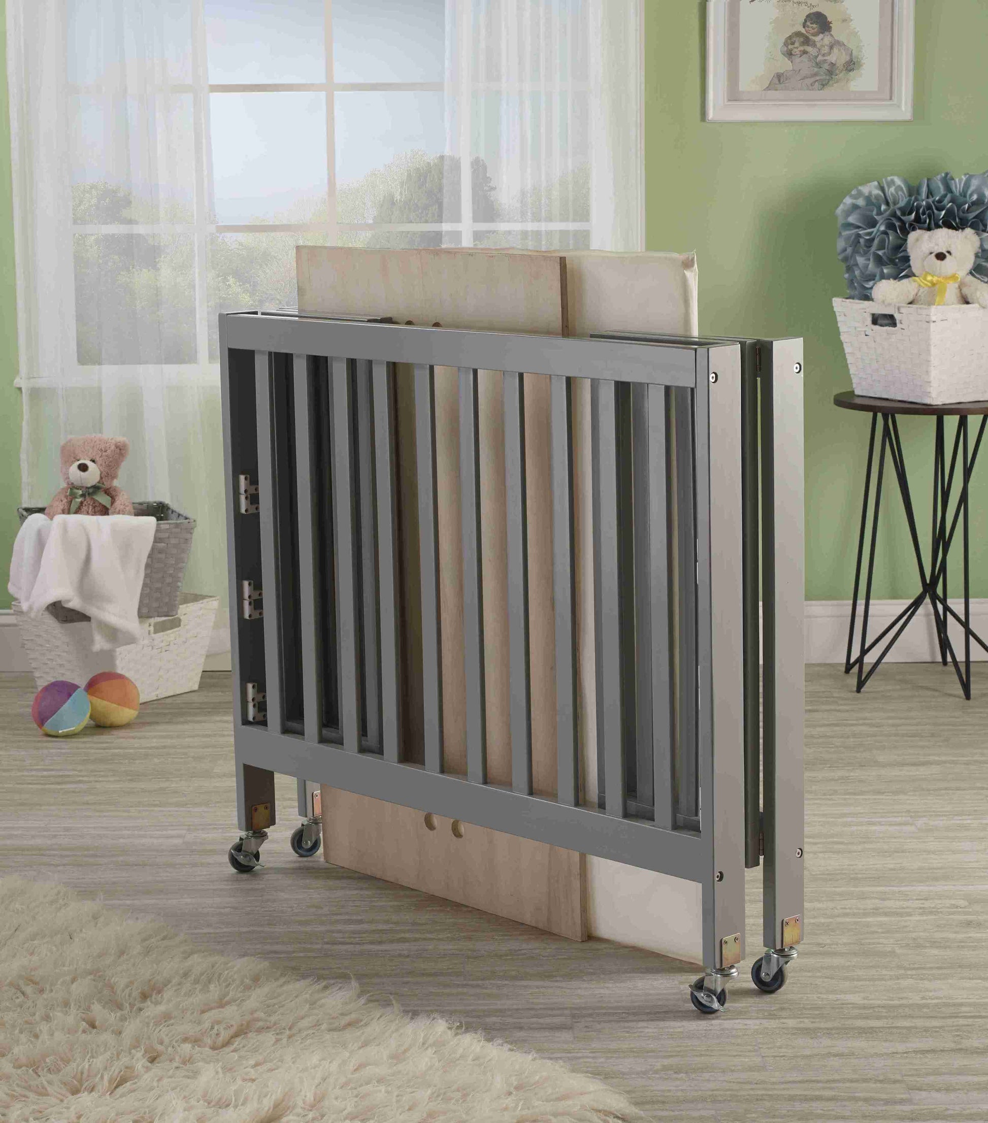 Roxy Three Level Mini Portable Folding Crib - Lifestyle Image of Mini Portable Crib Collapsed Gray