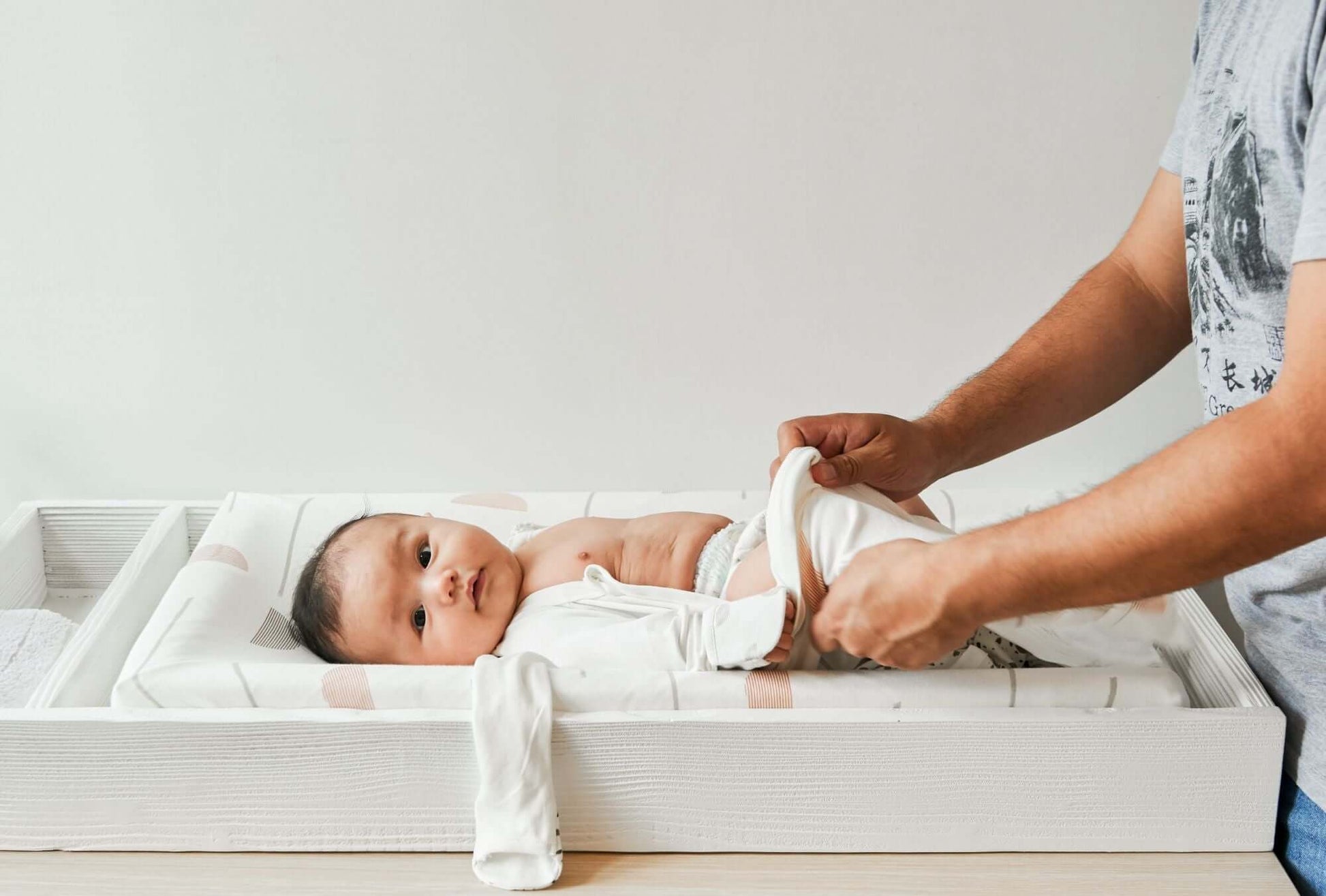 True Changer Tray - Side View Lifestyle Image of Changer Tray Snowstrom with Mother Changing Daiper