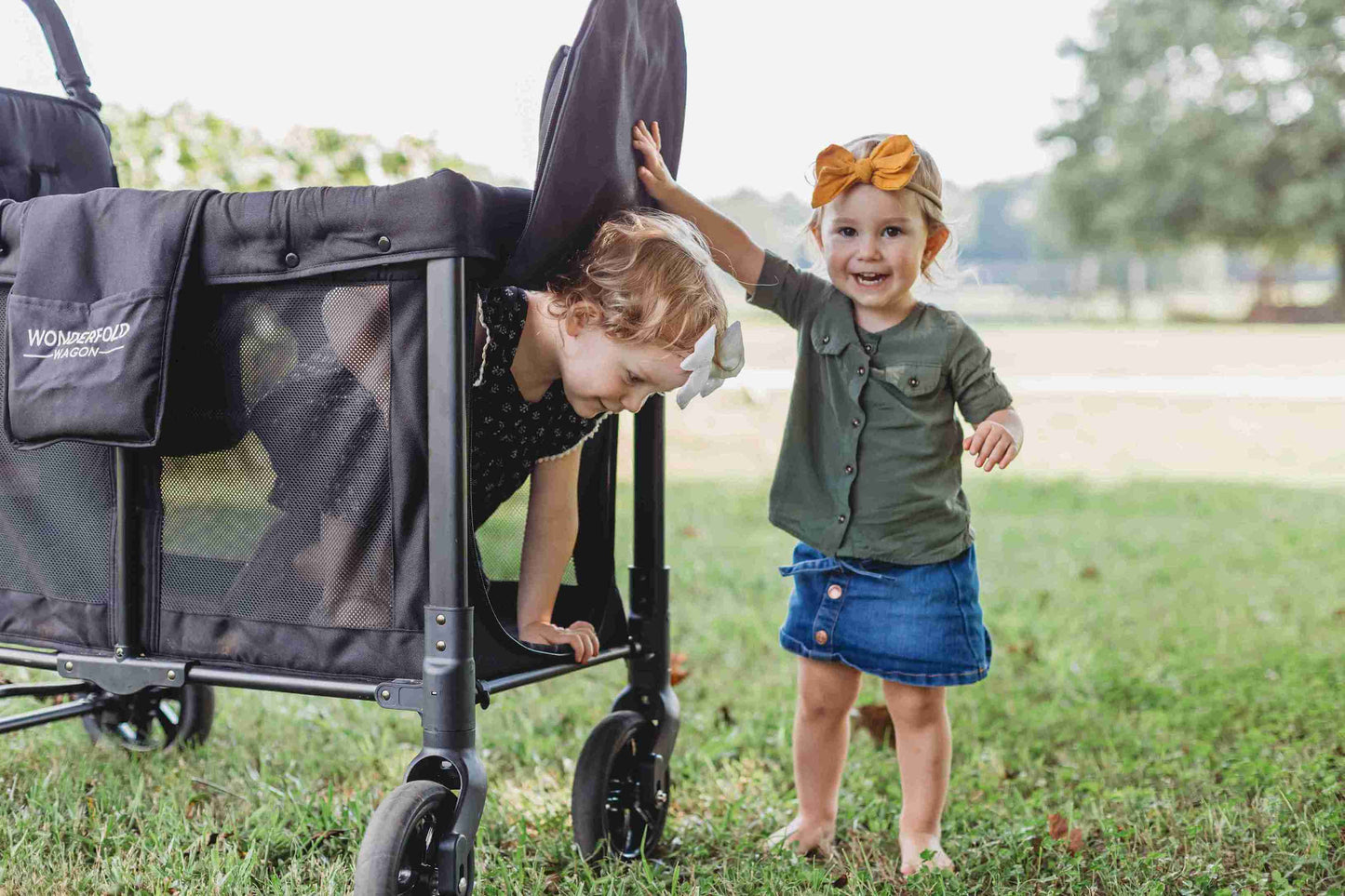 W2 Original + Double Stroller Wagon - Lifestyle Image Zoomed View of Toddler Getting Out of W2 Original + Double Stroller Wagon Black