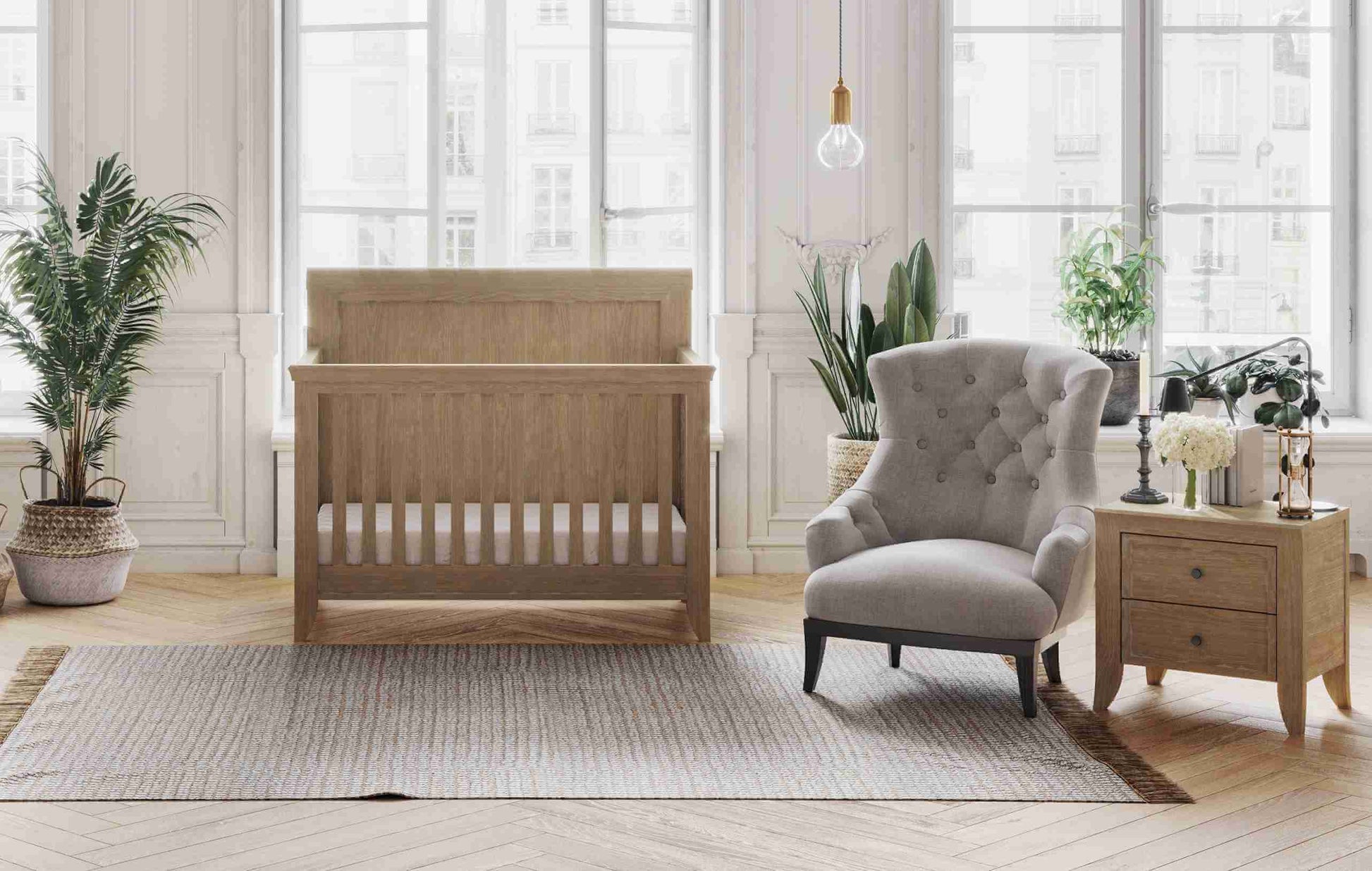 Cameo Oval Convertible Crib - Lifestyle Image Front View of Oval Toddler Bed Toast with 2 Drawer Nightstand