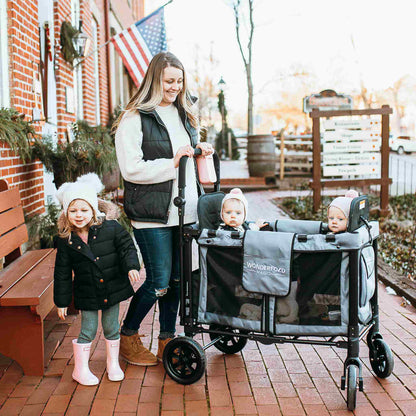 W2 Original + Double Stroller Wagon - Lifestyle Image Side View of Mother With Teenager and Toddler on W2 Original + Double Stroller Wagon Gray