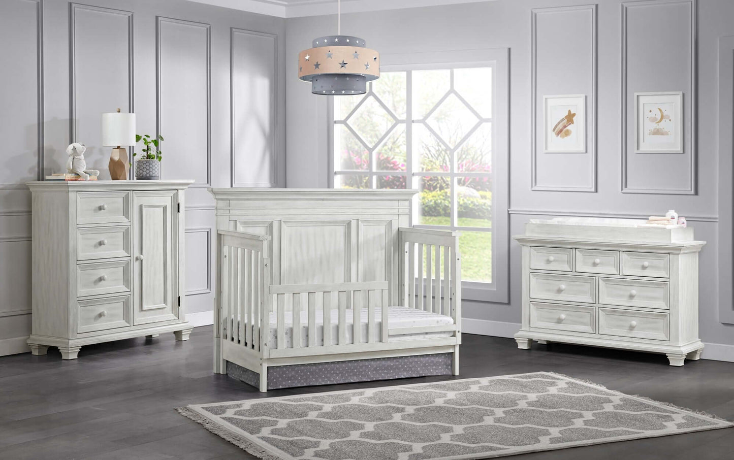 Weston 4 In 1 Convertible Crib - Lifestyle Image Inclined Side View of Weston 4 In 1 Convertible Crib with Guard Rail Vintage White 